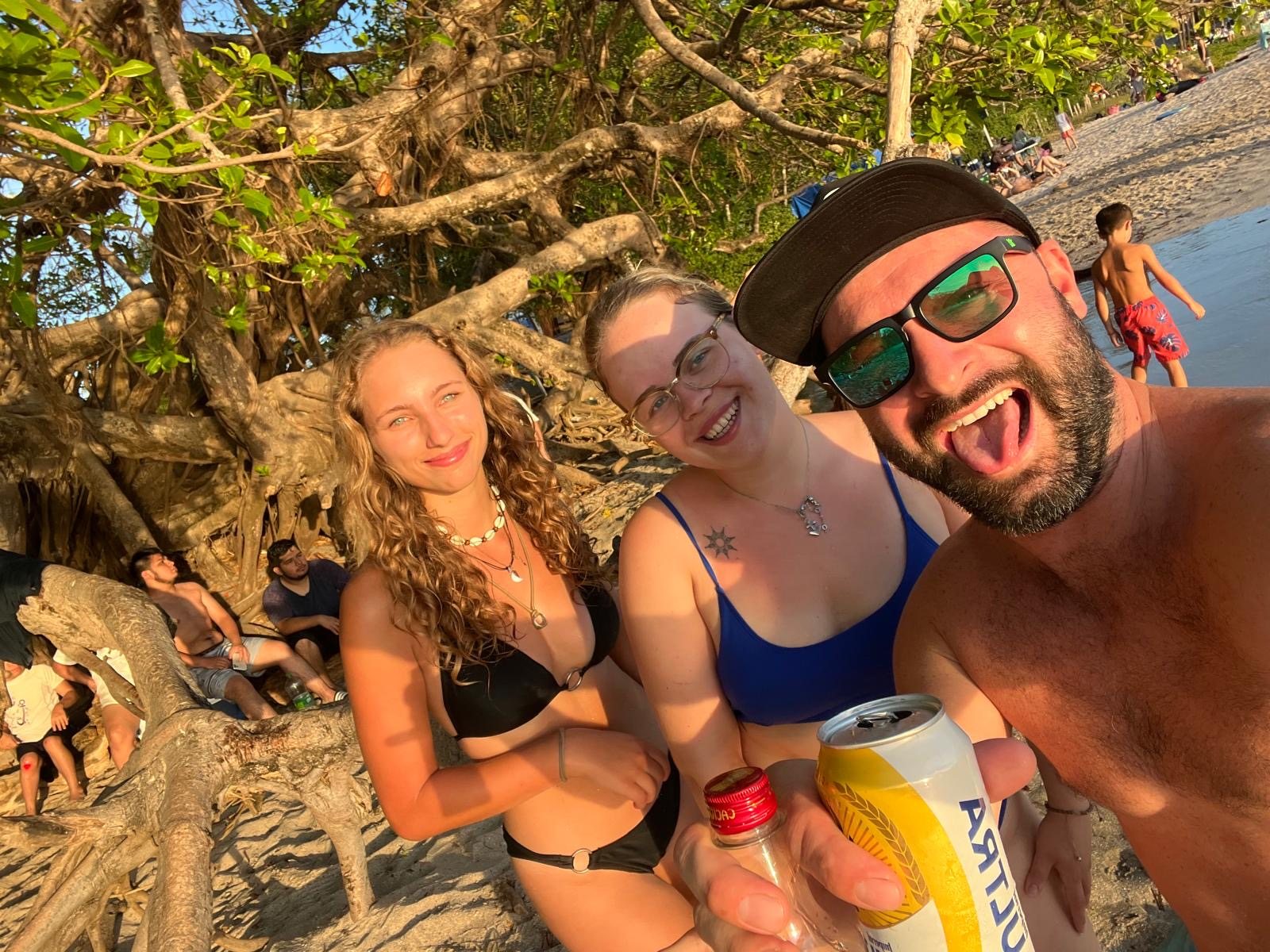 Friends smiling together on a beach