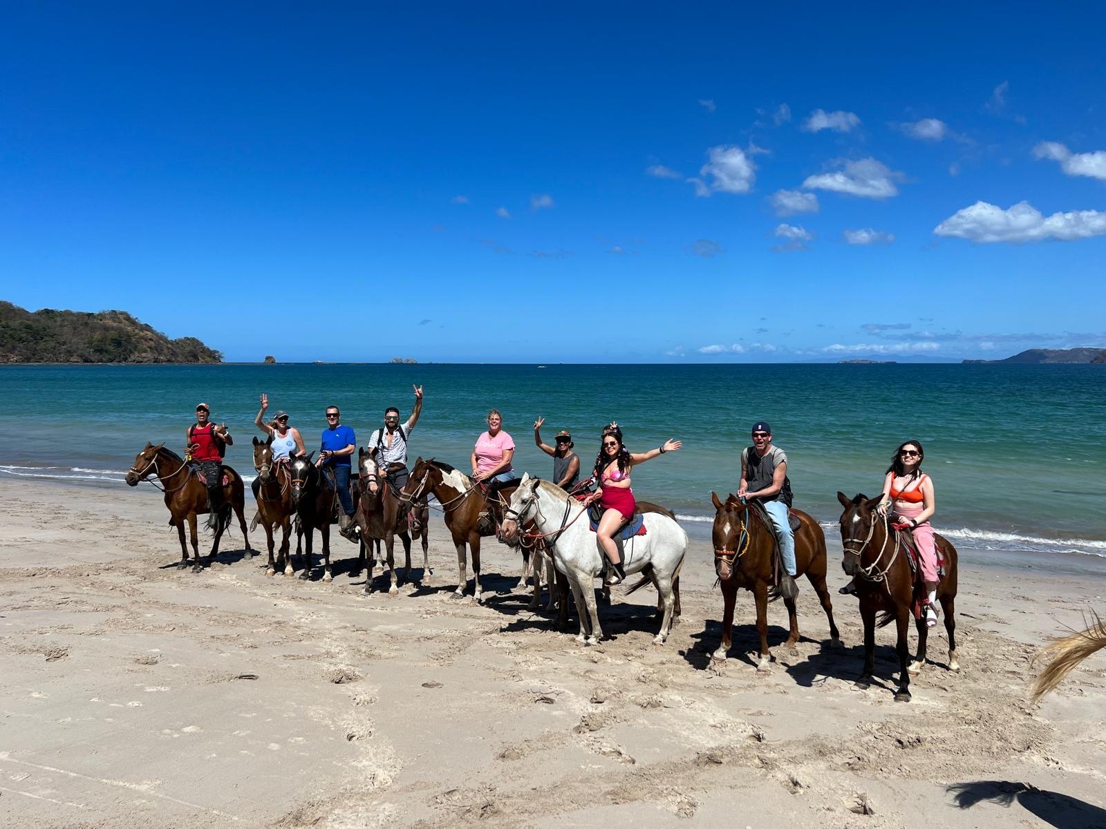 Guests on horseback along a Costa Rican beach