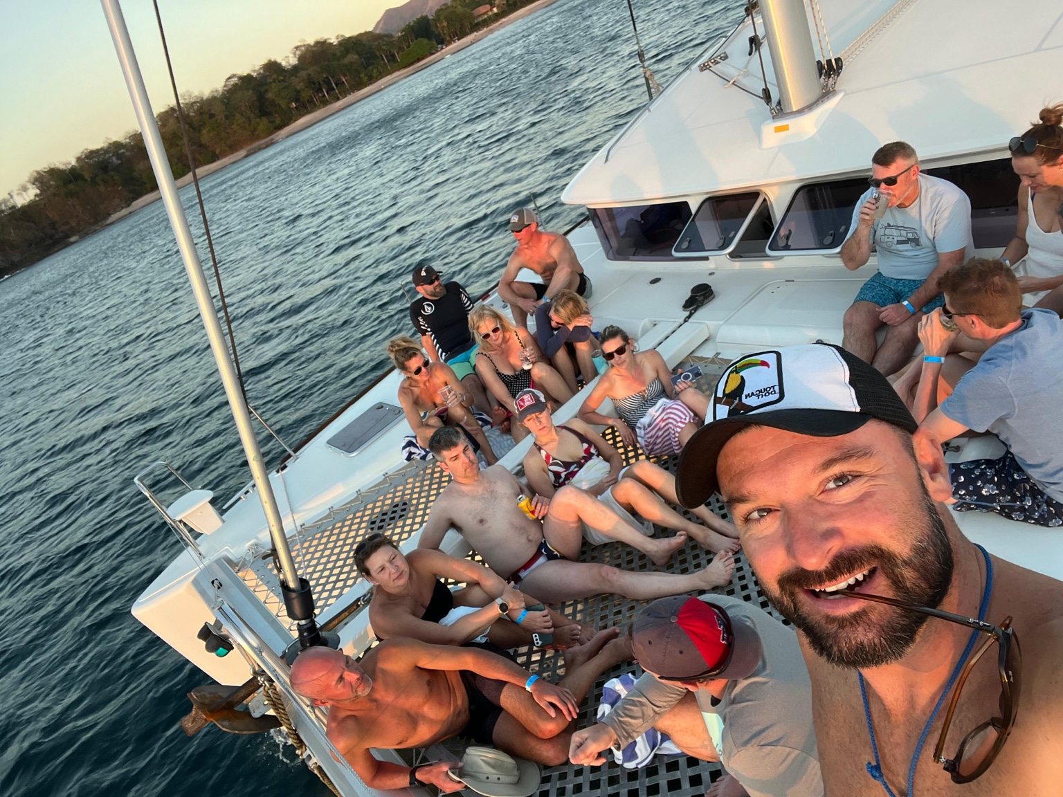 Friends smiling together aboard a sailboat