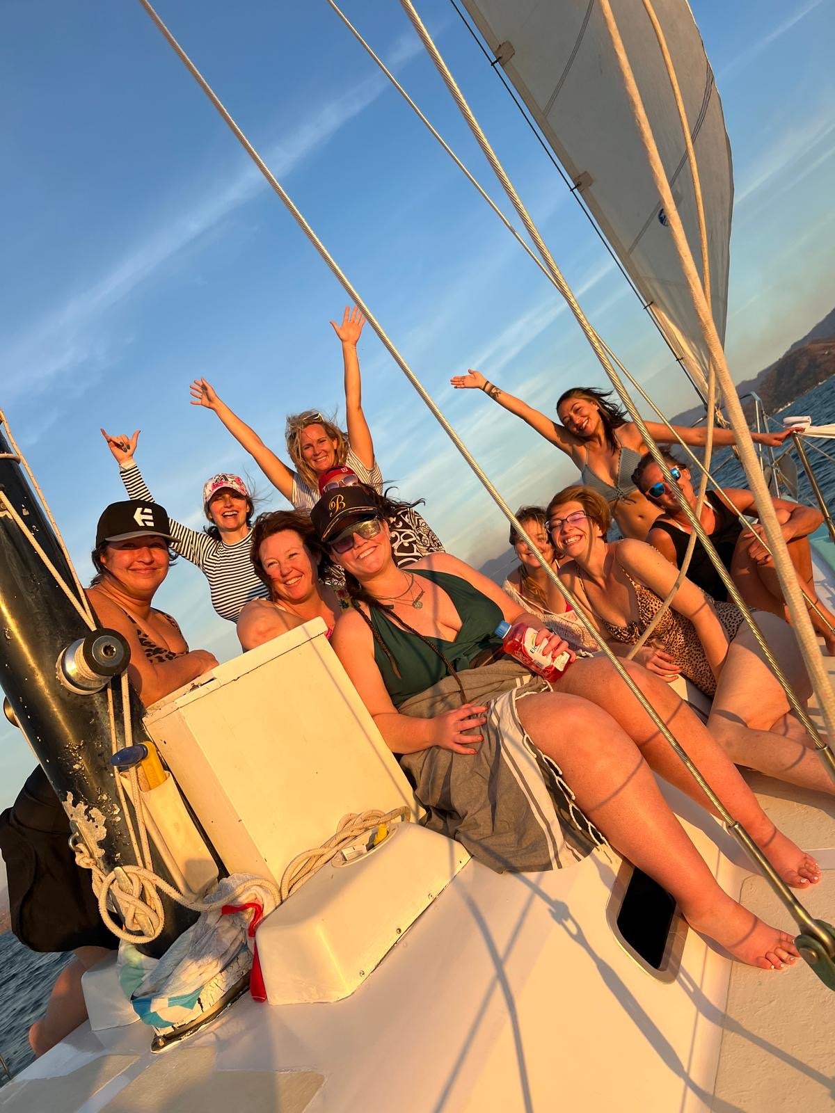 Friends smiling on a sunset sail